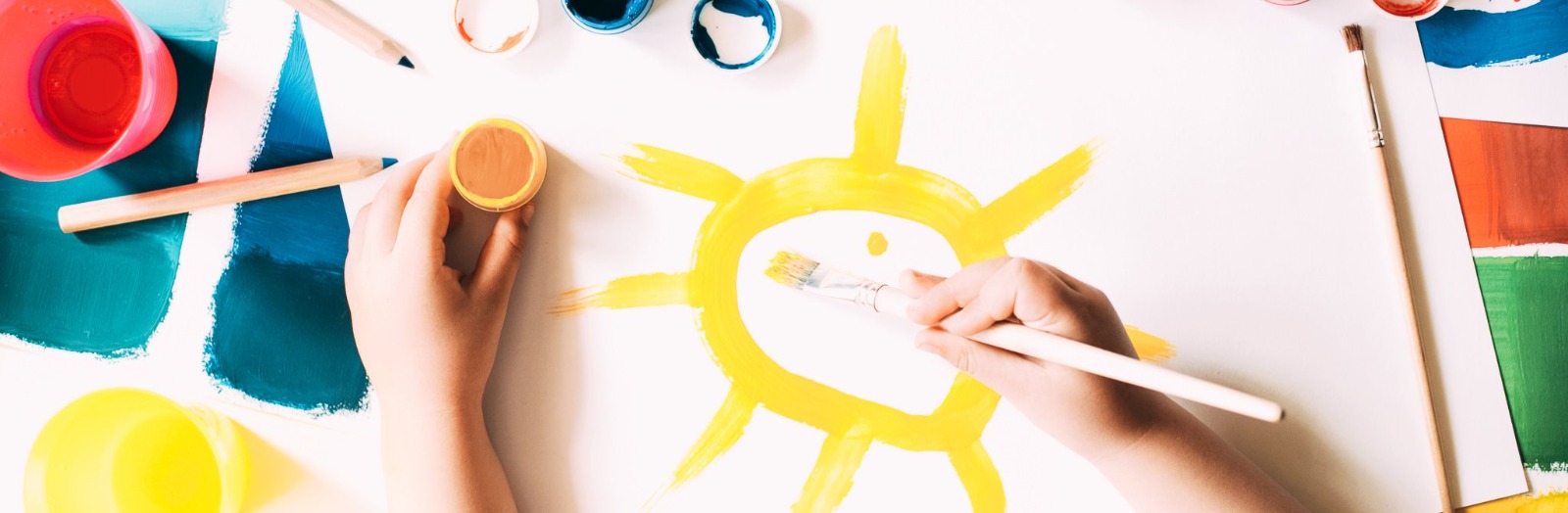 Child painting a sun