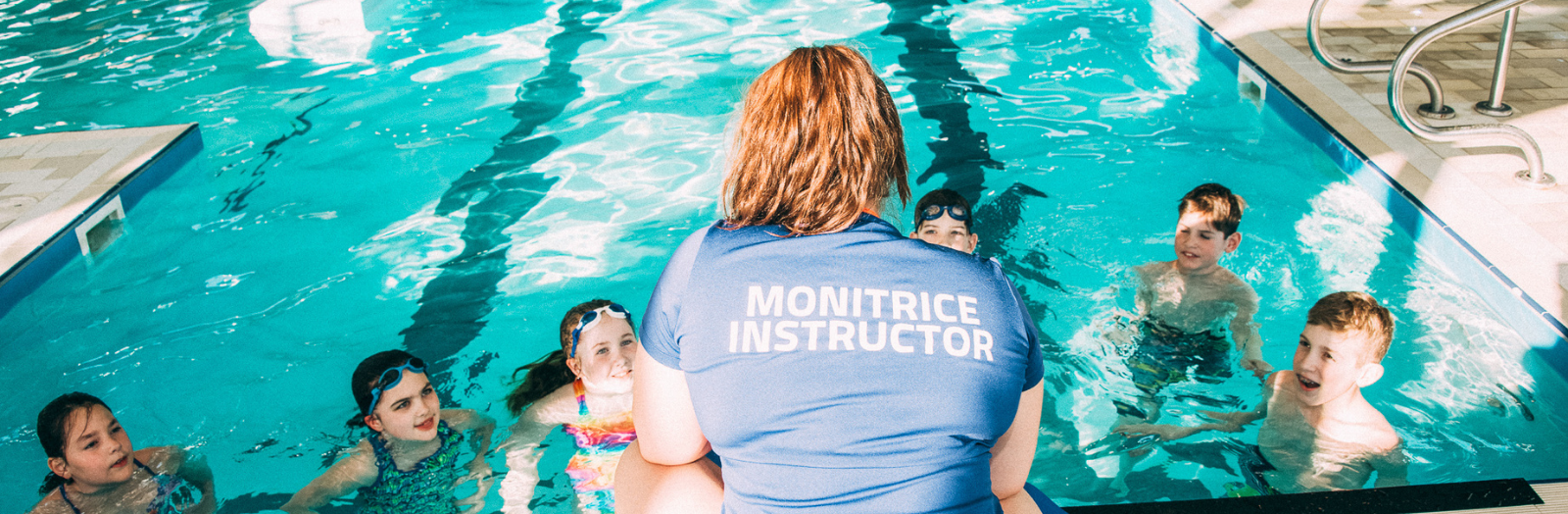 Swim instructor teaching a swimming lesson