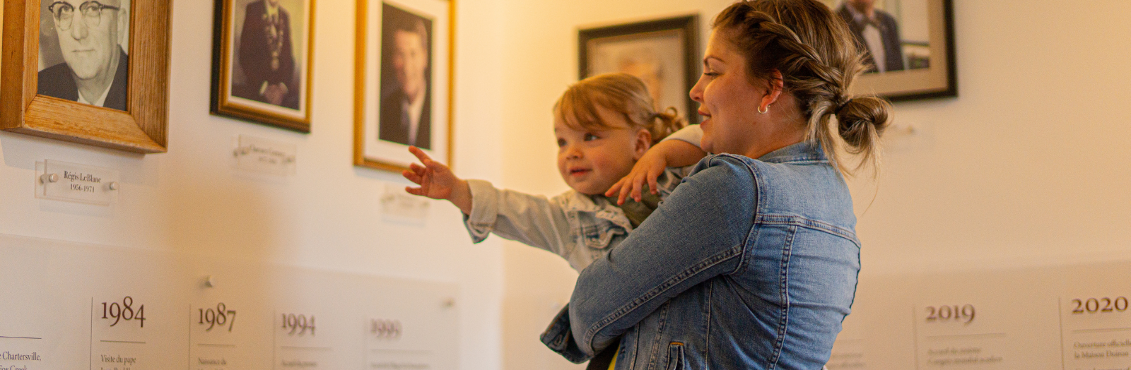 Family looking at an exhibition of vintage picturess