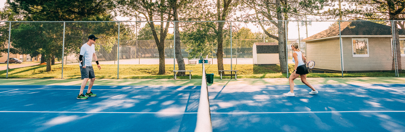 Woman and man playing tennis