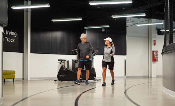 Couple walking on the JD Irving Indoor Walking Track